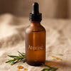 Atorisé Research-Grade Hair Growth Oil - Frosted amber glass bottle with rosemary sprigs