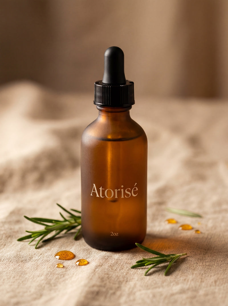 Atorisé Research-Grade Hair Growth Oil - Frosted amber glass bottle with rosemary sprigs