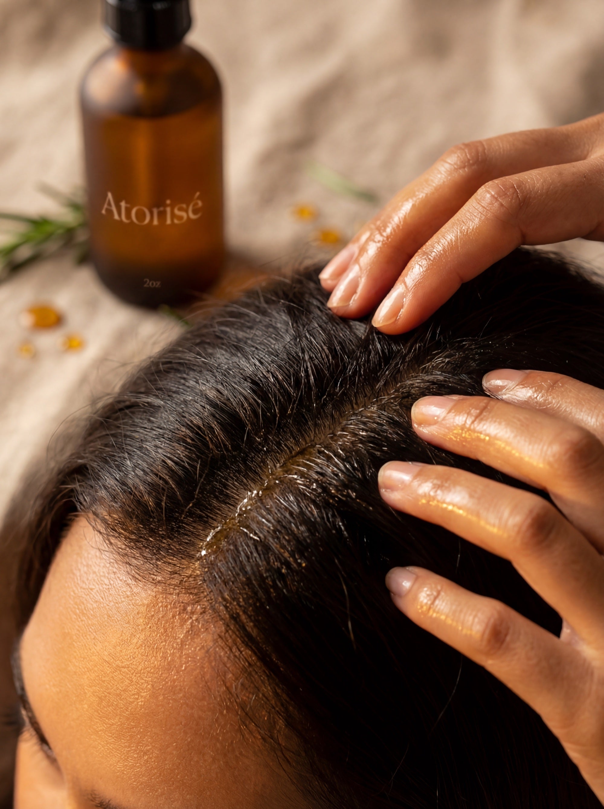 Scalp massage ritual with Atorisé oil - fingers working oil into the scalp