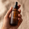 Atorisé 2oz bottle held in hand - compact and portable size